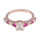 Teresa rose gold ring with emerald cut center stone and alternating rubies and diamonds contemporary red gemstone ring